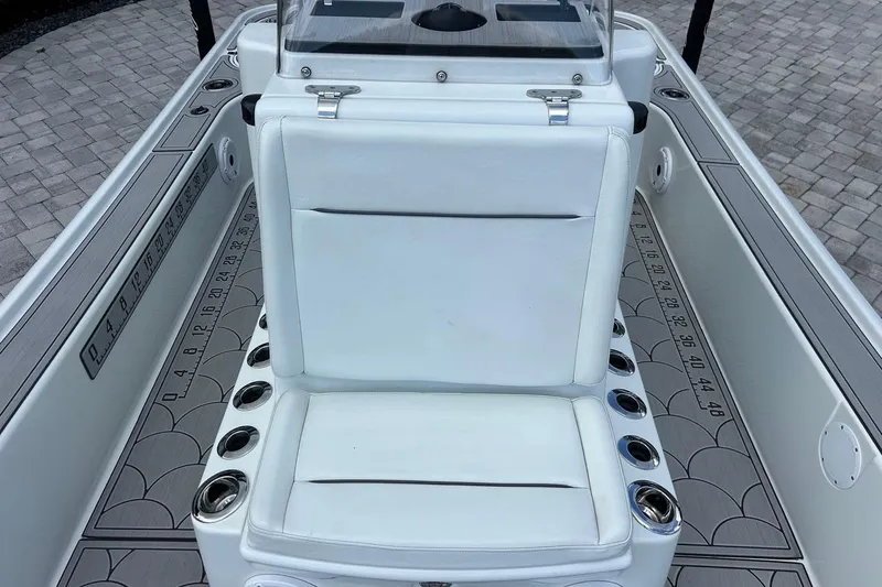 Slide: The Image of 2016 Yellowfin 24 Bay boat interior with white seating and cup holders. - 25