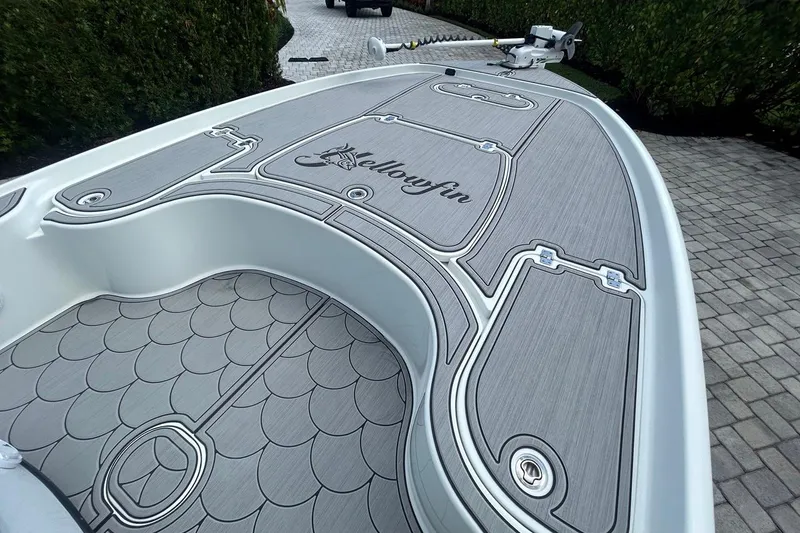 Slide: The Image of 2016 Yellowfin 24 Bay boat with custom deck design on a paved driveway. - 28