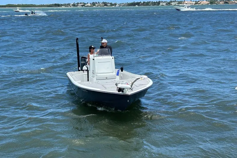 Slide: The Image of 2016 Yellowfin 24 Bay boat cruising on open water with two passengers. - 3