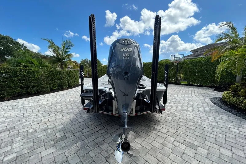 Slide: The Image of 2016 Yellowfin 24 Bay boat with Yamaha 300 V6 engine in a sunny driveway. - 34