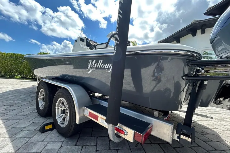 Slide: The Image of 2016 Yellowfin 24 Bay boat on trailer under a cloudy sky. - 36