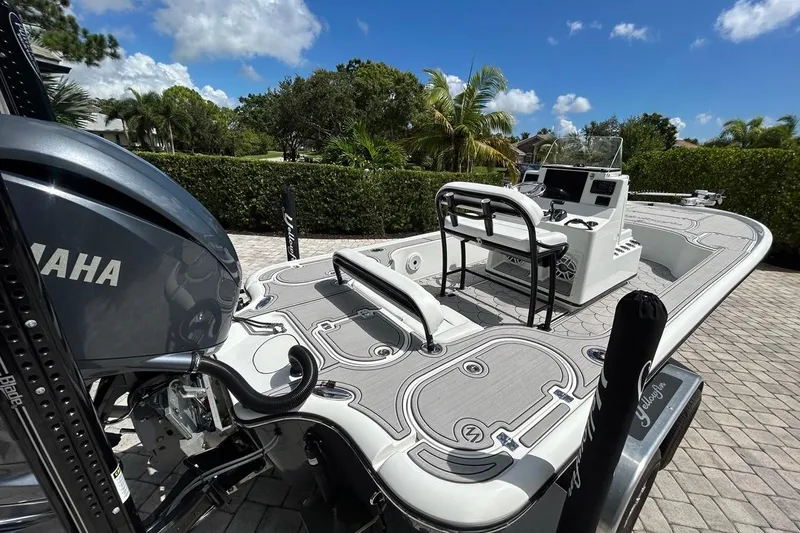 Slide: The Image of 2016 Yellowfin 24 Bay boat with Yamaha engine, parked on a sunny day. - 38
