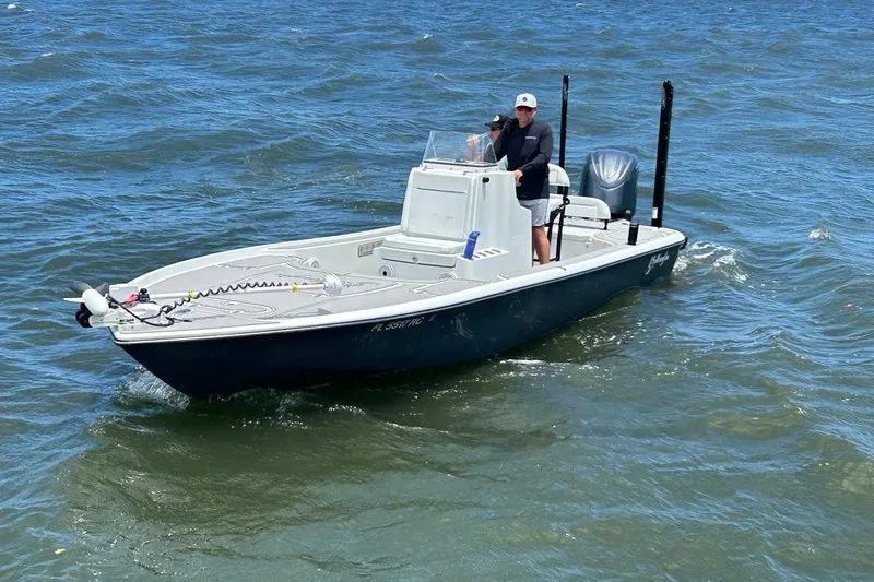 Slide: The Image of 2016 Yellowfin 24 Bay boat on water with person steering. - 4