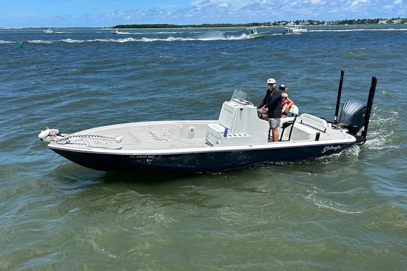 Slide: The Image of 2016 Yellowfin 24 Bay boat cruising on open water with passengers onboard. - 5