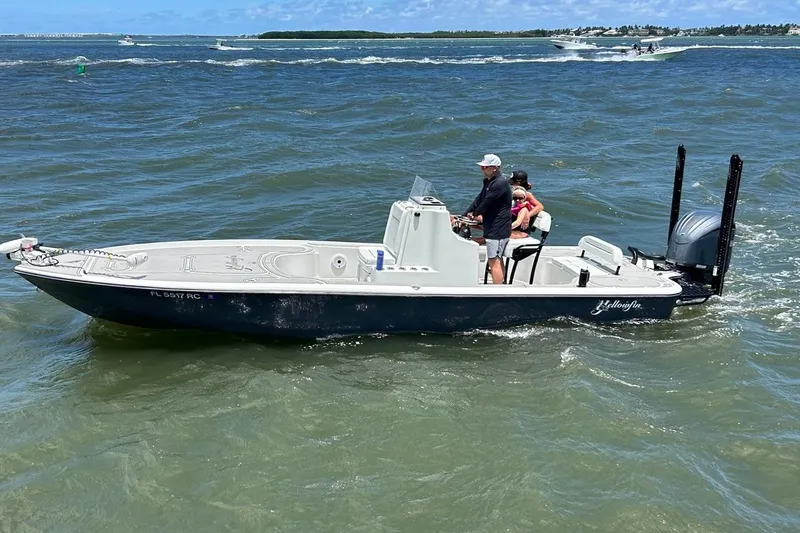 Slide: The Image of 2016 Yellowfin 24 Bay boat cruising on open water with passengers onboard. - 6