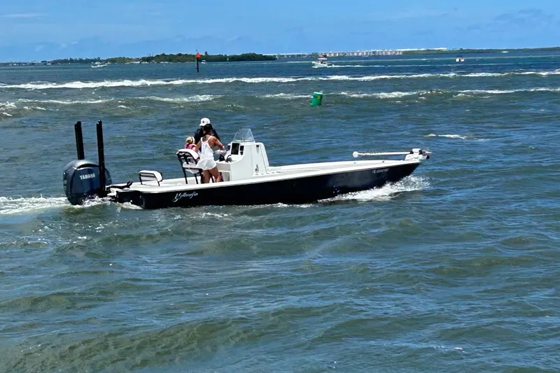 Slide: The Image of 2016 Yellowfin 24 Bay boat cruising on open water with passengers. - 7