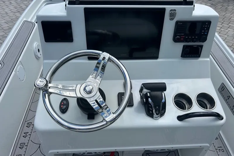 Slide: The Image of 2016 Yellowfin 24 Bay boat console with steering wheel and controls. - 8