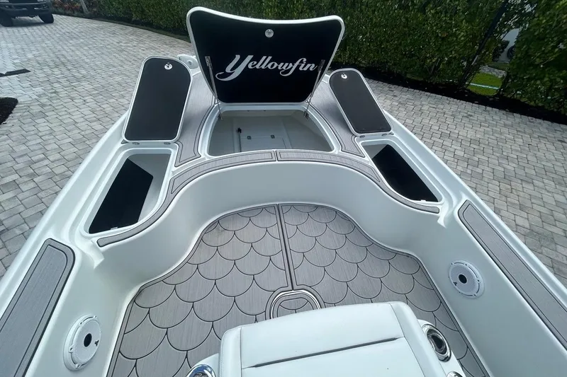 Slide: The Image of 2016 Yellowfin 24 Bay boat interior with open storage compartments and stylish flooring. - 9
