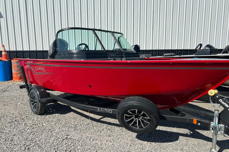 The Image of 2026 Lund 1650 Rebel XL Sport boat in vibrant red on a trailer. - 1