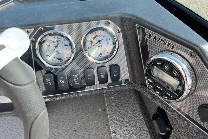 Slide: The Image of Dashboard of 2026 Lund 1650 Rebel XL Sport boat with gauges and controls. - 10