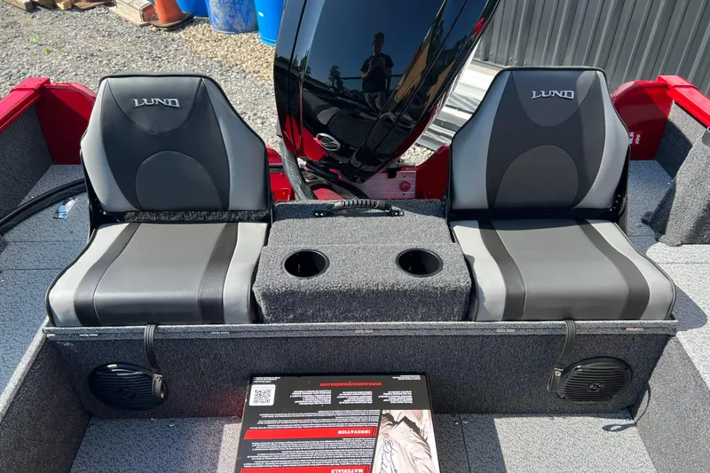 Slide: The Image of 2026 Lund 1650 Rebel XL Sport boat interior with dual seats and cup holders. - 7