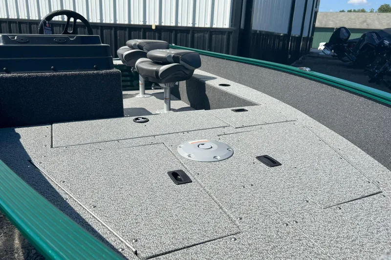 Slide: The Image of 2026 Lund 1650 Angler SS boat interior with seating and storage compartments. - 12