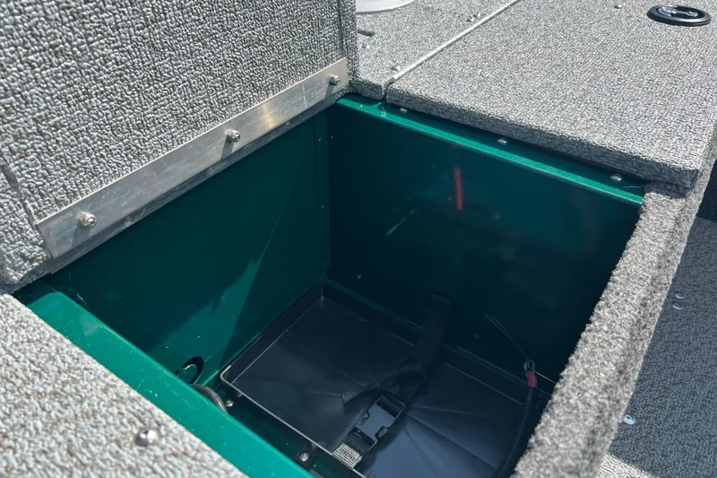 Slide: The Image of 2026 Lund 1650 Angler SS boat storage compartment with textured interior. - 13