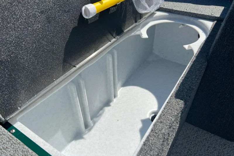 Slide: The Image of 2026 Lund 1650 Angler SS boat storage compartment with textured interior. - 14