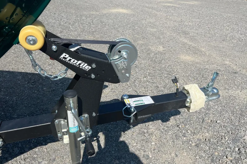 Slide: The Image of Trailer hitch and winch of 2026 Lund 1650 Angler SS on gravel surface. - 4