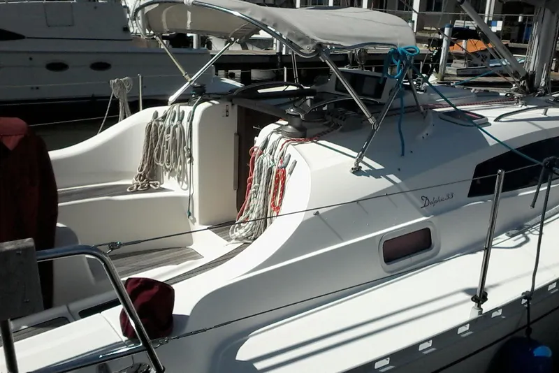 Slide: The Image of 2007 Delphia 33 sailboat docked, featuring sleek design and nautical equipment. - 10