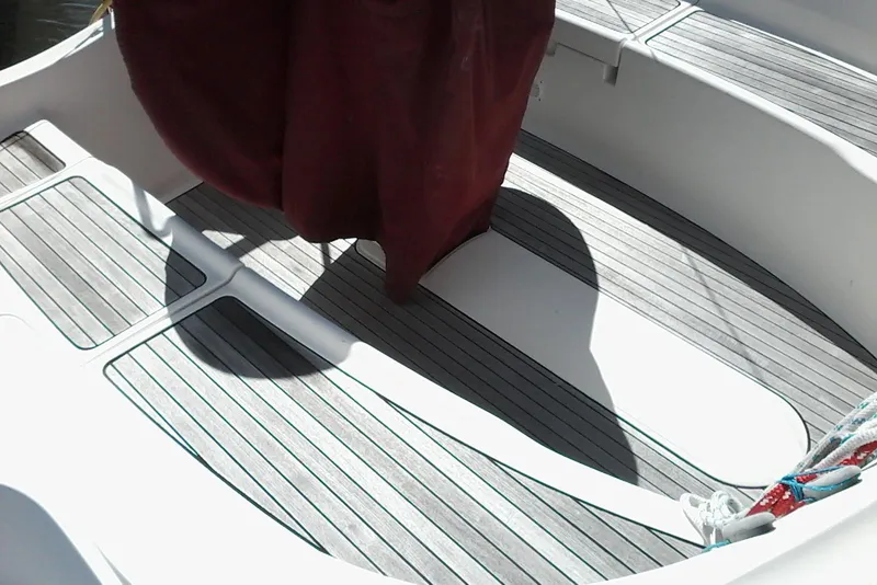Slide: The Image of Interior view of a 2007 Delphia 33 sailboat with wooden flooring. - 11
