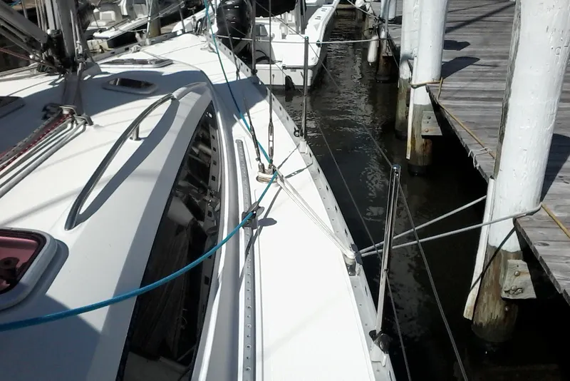 Slide: The Image of Delphia 33 sailboat from 2007 docked at a marina, showcasing deck details. - 15