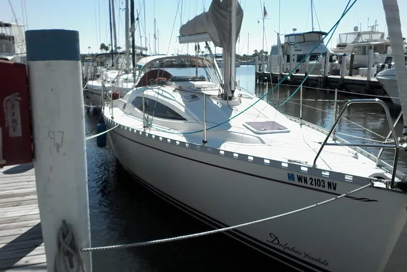 Slide: The Image of Sailboat Delphia 33, 2007 model, docked at marina with clear skies. - 9