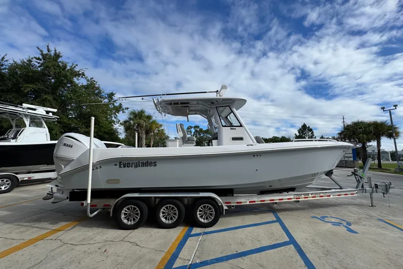 Slide: The Image of 2022 Everglades 295 Center Console boat on trailer under blue sky. - 10