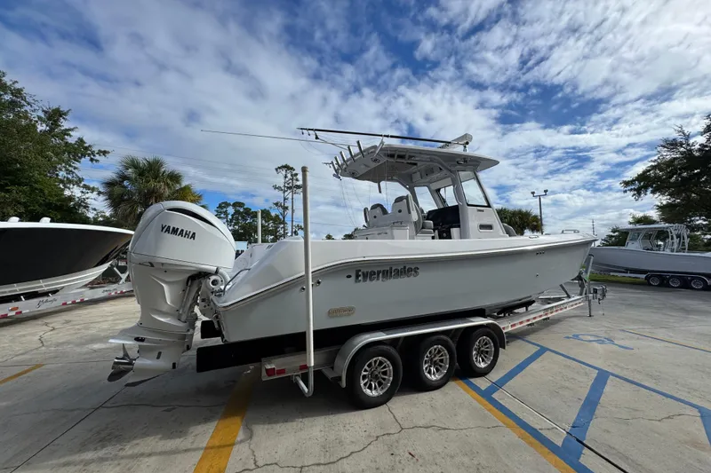 Slide: The Image of 2022 Everglades 295 Center Console boat on trailer, featuring Yamaha engine. - 11