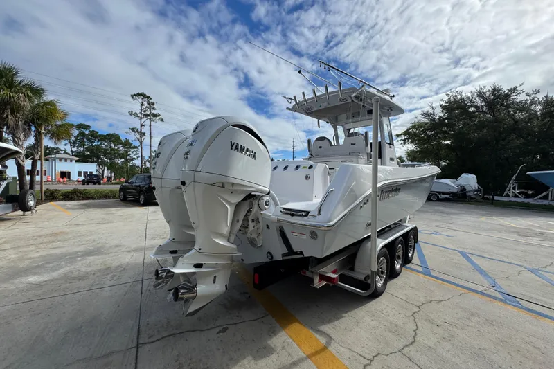 Slide: The Image of 2022 Everglades 295 Center Console boat with dual Yamaha engines on a trailer. - 12