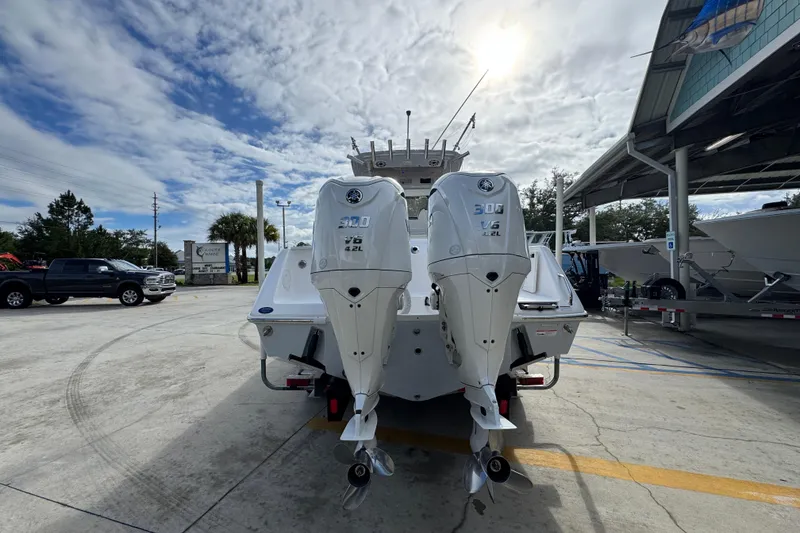 Slide: The Image of 2022 Everglades 295 Center Console boat with twin 300 V6 engines at a marina. - 14