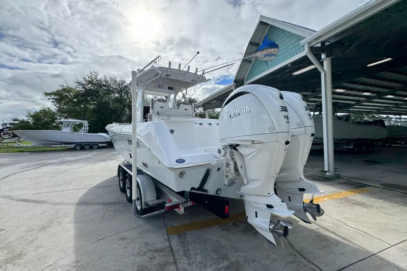 Slide: The Image of 2022 Everglades 295 Center Console boat with twin Yamaha engines on trailer. - 15