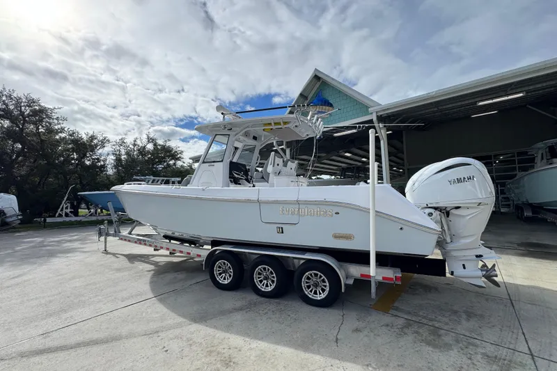 Slide: The Image of 2022 Everglades 295 Center Console boat on trailer, parked outdoors. - 17