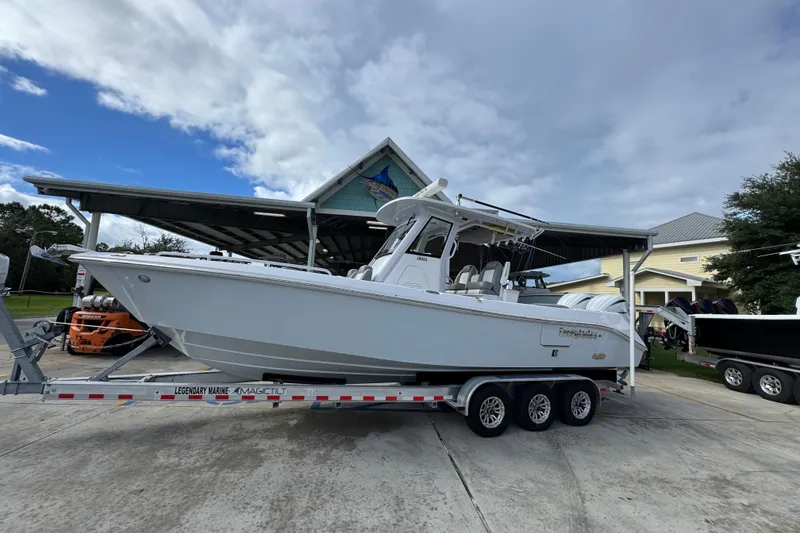 Slide: The Image of 2022 Everglades 295 Center Console boat on a trailer under a cloudy sky. - 2