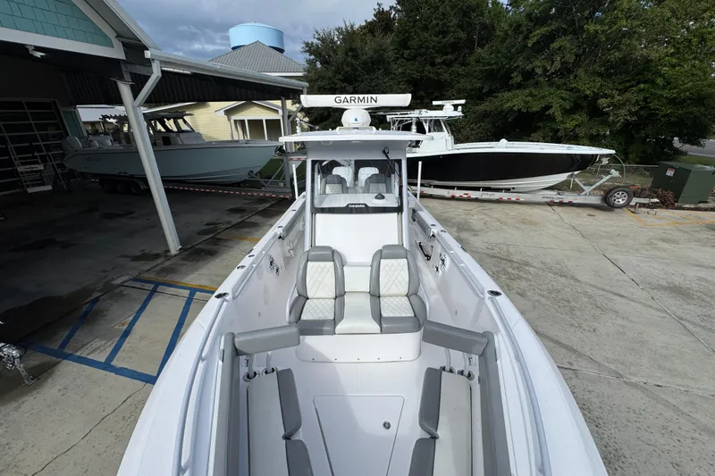 Slide: The Image of 2022 Everglades 295 Center Console boat with Garmin equipment, docked outdoors. - 23