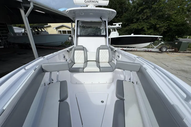 Slide: The Image of 2022 Everglades 295 Center Console boat interior with seating and console view. - 24