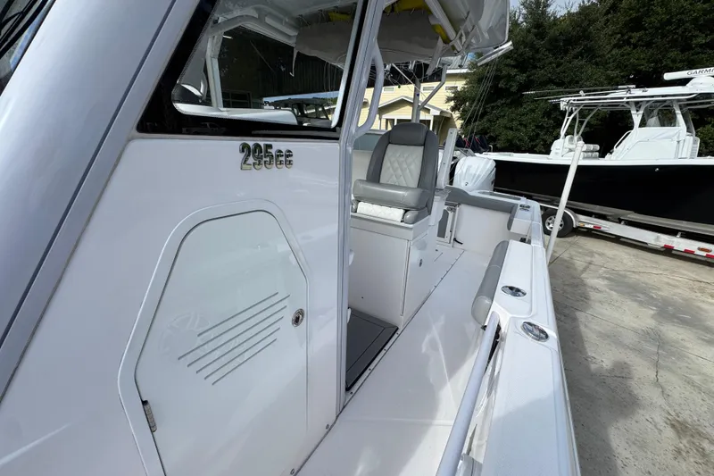 Slide: The Image of 2022 Everglades 295 Center Console boat, sleek design, white exterior, docked outdoors. - 25