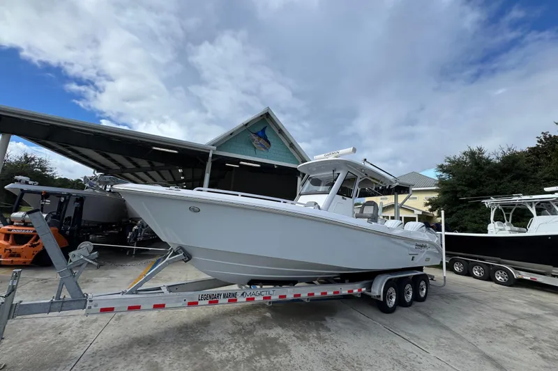 Slide: The Image of 2022 Everglades 295 Center Console boat on trailer at marina under cloudy sky. - 3