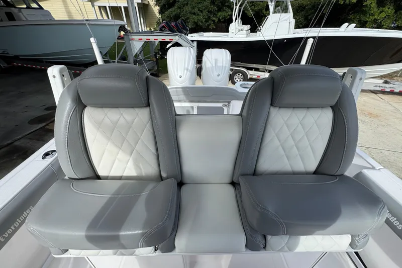 Slide: The Image of 2022 Everglades 295 Center Console boat with luxurious gray seating and diamond stitching. - 31