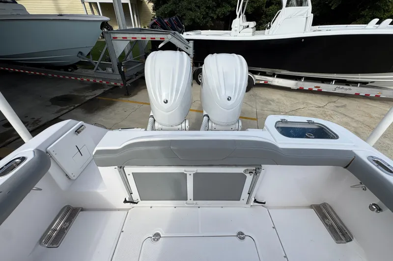 Slide: The Image of 2022 Everglades 295 Center Console boat with dual engines, docked on a trailer. - 39
