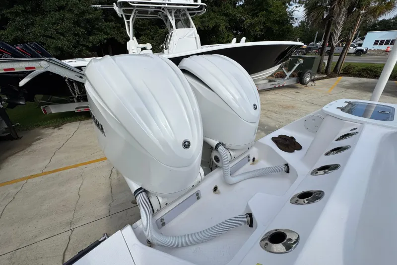Slide: The Image of 2022 Everglades 295 Center Console with dual outboard engines, parked on a trailer. - 41