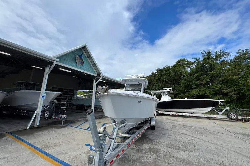Slide: The Image of 2022 Everglades 295 Center Console boat on trailer outside a marina. - 5