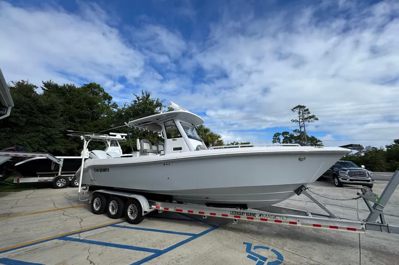 Slide: The Image of 2022 Everglades 295 Center Console boat on trailer under blue sky. - 8