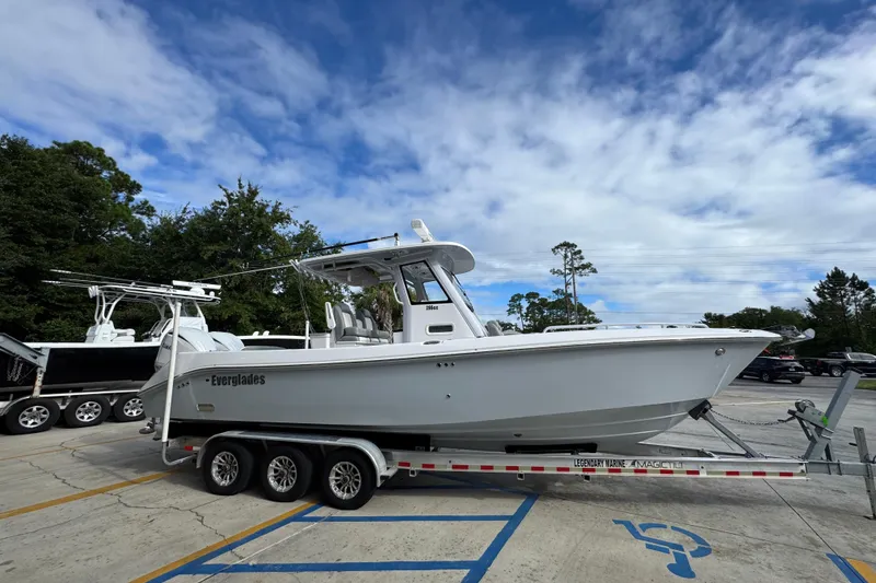 Slide: The Image of 2022 Everglades 295 Center Console boat on trailer under blue sky. - 9