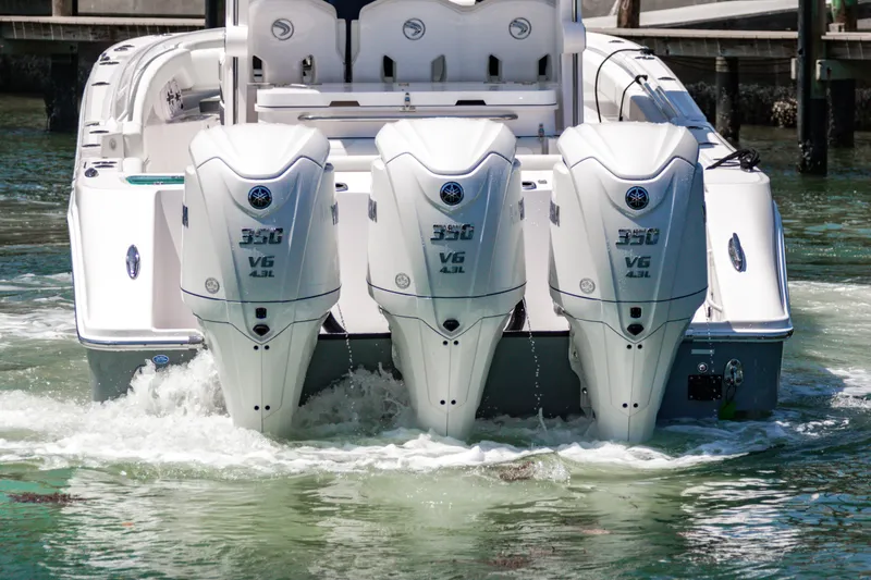 Slide: The Image of 2025 Edgewater 370CC boat with triple Yamaha 350 V6 engines in water. - 7