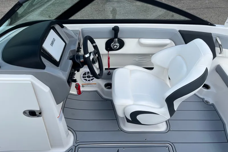 Slide: The Image of 2026 Chaparral 21 SSi boat interior with white captain's seat and modern dashboard. - 14