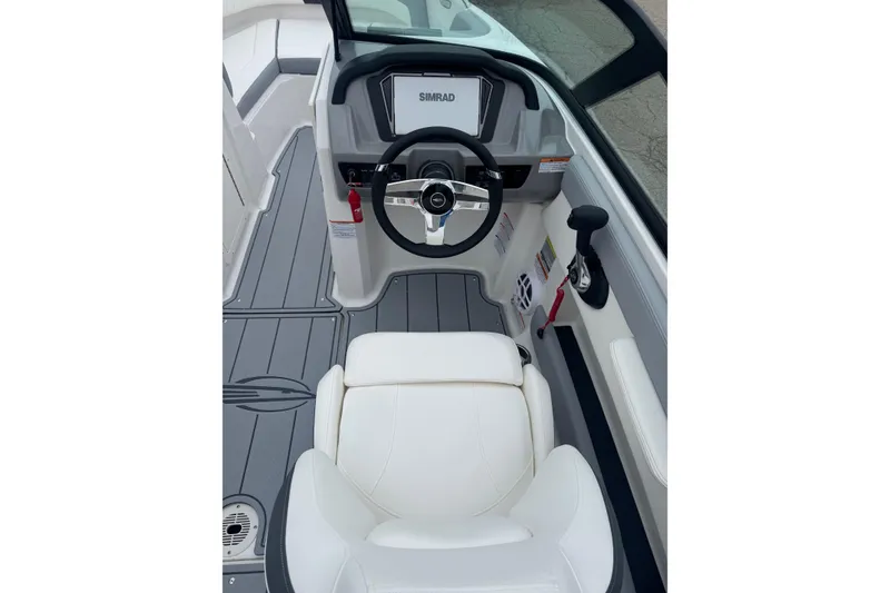 Slide: The Image of Interior view of 2026 Chaparral 21 SSi boat cockpit with steering wheel and controls. - 15