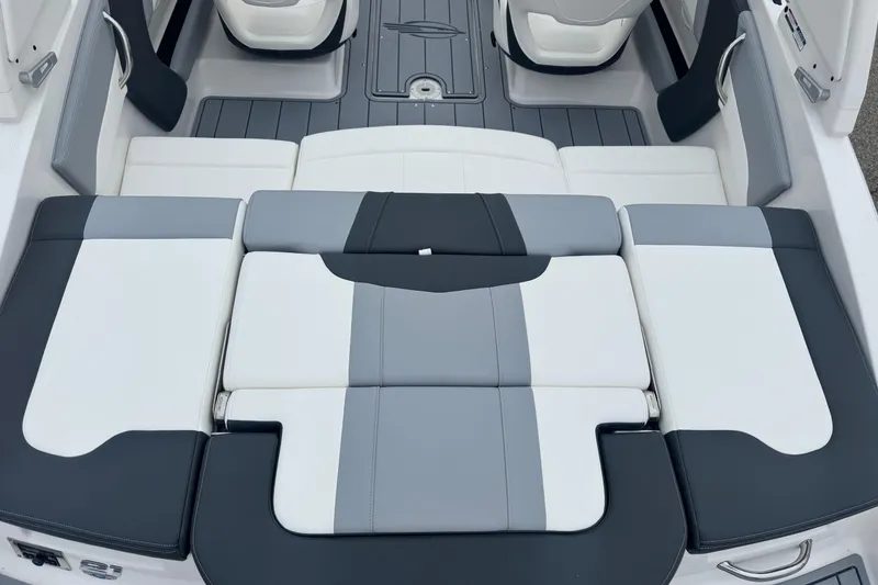 Slide: The Image of 2026 Chaparral 21 SSi boat interior with sleek, modern seating design in gray and white. - 2