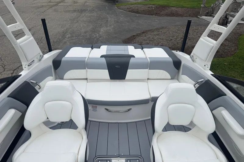 Slide: The Image of 2026 Chaparral 21 SSi boat interior with white and gray cushioned seating. - 21