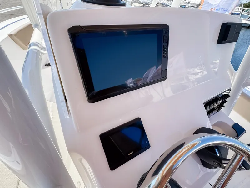 Slide: The Image of 2025 Edgewater 208CC boat dashboard with modern navigation screens and steering wheel. - 13