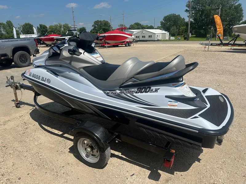 Slide: The Image of 2012 Kawasaki 300 LX Ultra jet ski on trailer, parked outdoors on a sunny day. - 6