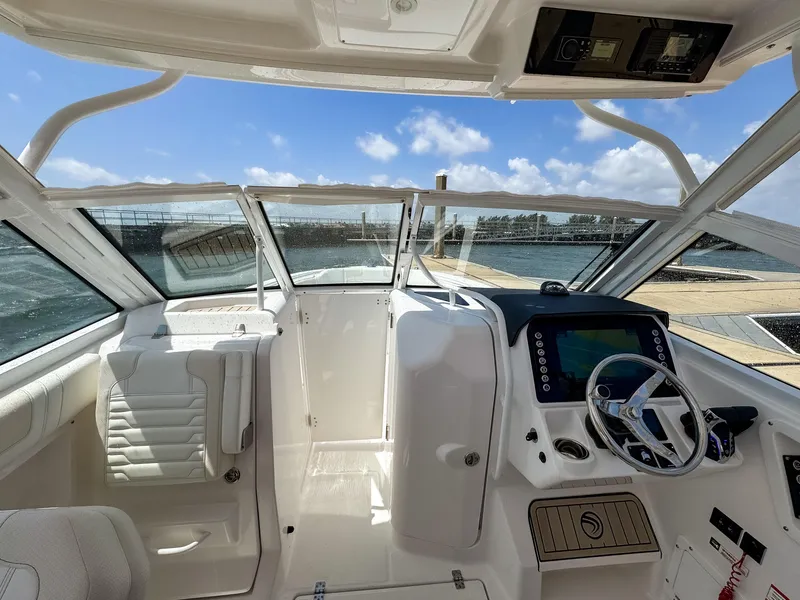 Slide: The Image of Interior view of 2025 Edgewater 262 CX boat with modern dashboard and steering wheel. - 11