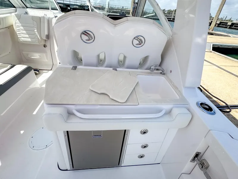Slide: The Image of 2025 Edgewater 262 CX boat interior with kitchenette, sink, and storage drawers. - 24