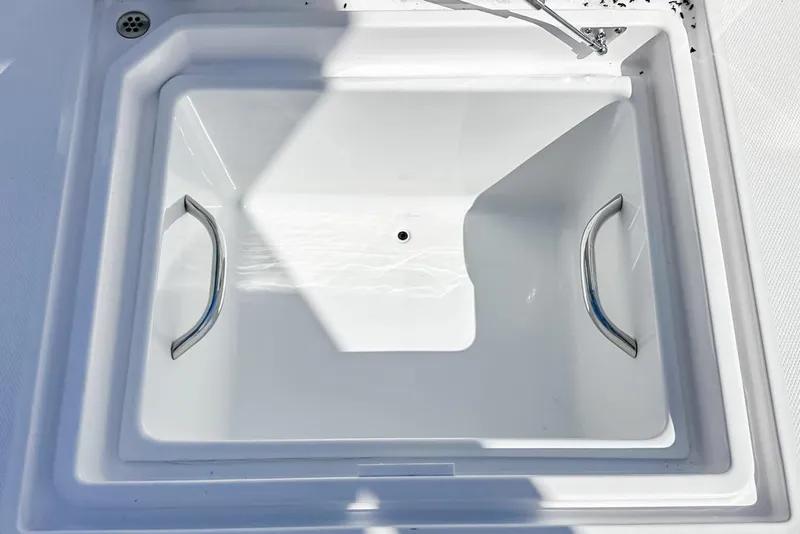 Slide: The Image of 2025 Edgewater 262CX Crossover boat storage compartment with stainless steel handles. - 37